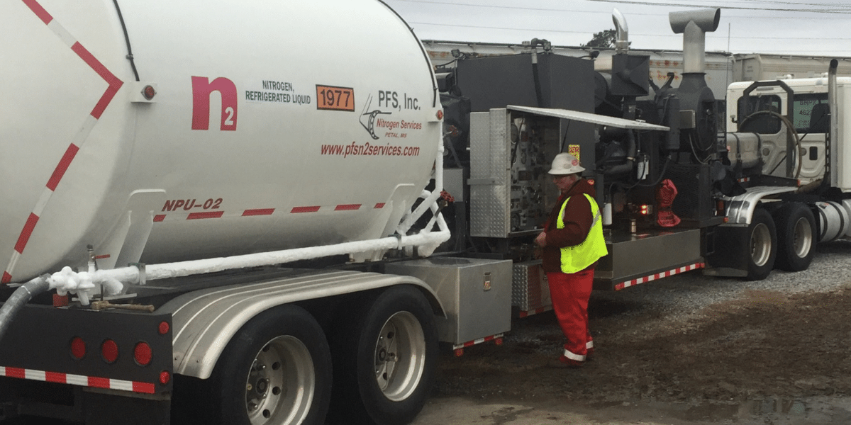 N2 employee with safety hat and vest working on truck control system